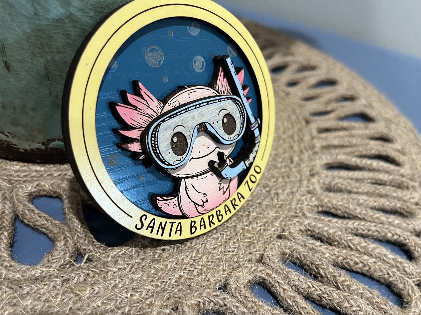 Custom laser-engraved wood magnet of a snorkeling axolotl for the Santa Barbara Zoo